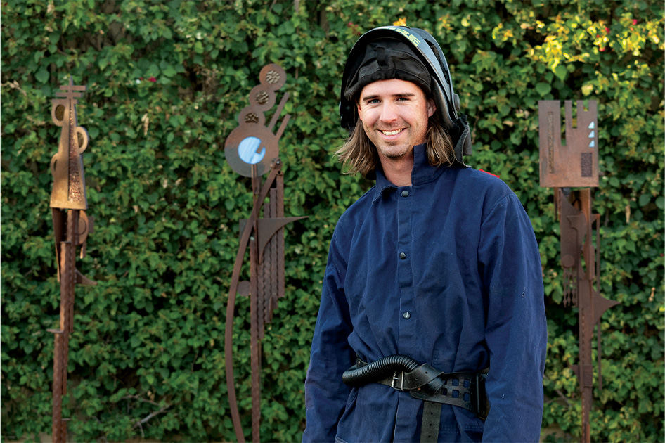 Ryan McCallister standing in front of trail markers