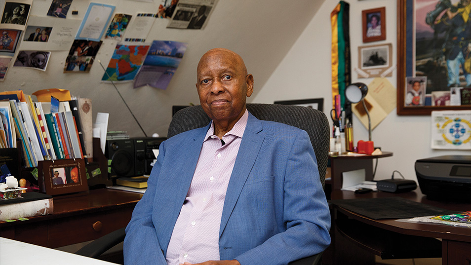  A MAN SITTING BEHIND A DESK