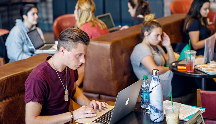 Students at Starbucks studying on laptops