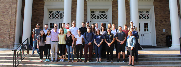 Group of people standing outside of Sykes College of Business