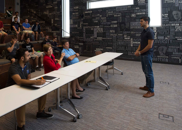 People listening to a person giving a pitch