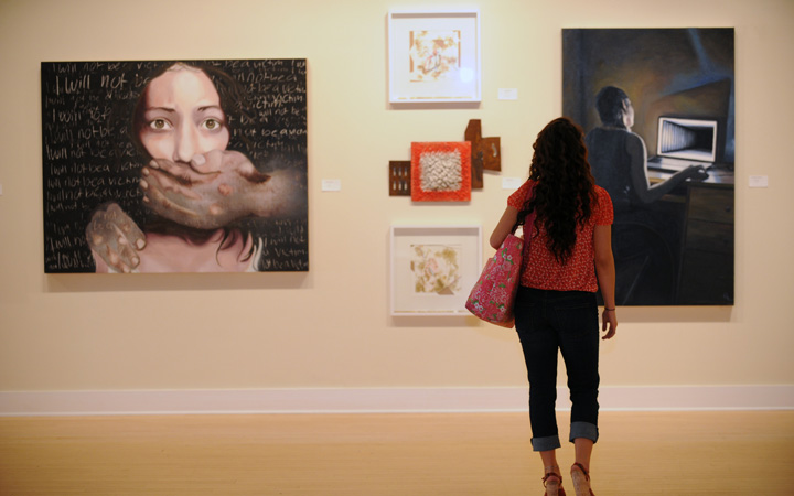 Lady looking at art in a gallery