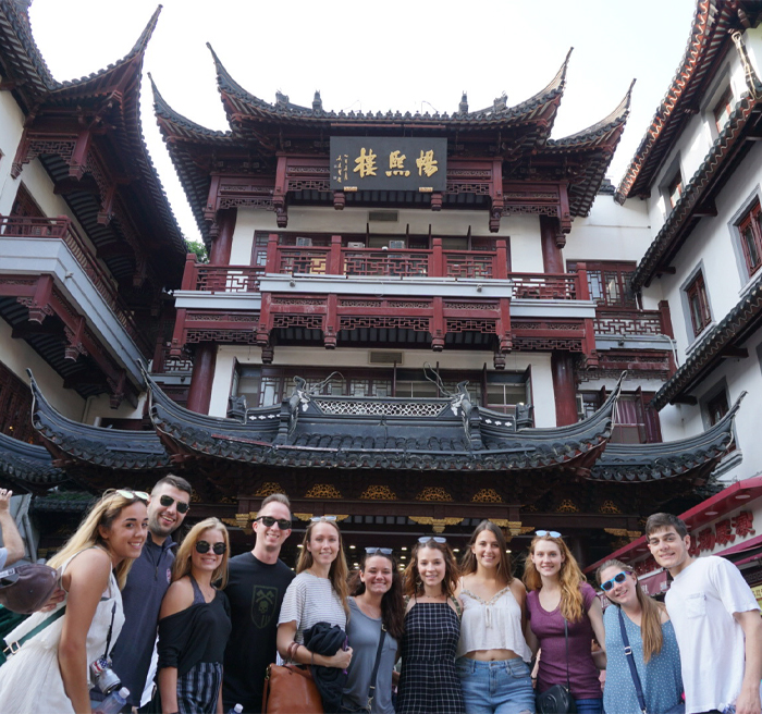 University of Tampa students in front of a temple