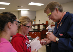 Tom Jackman talking to 2 students