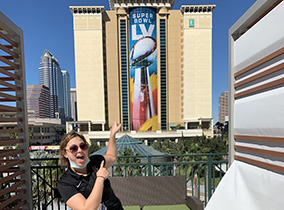 Students pointing at Super Bowl LV (55) banner