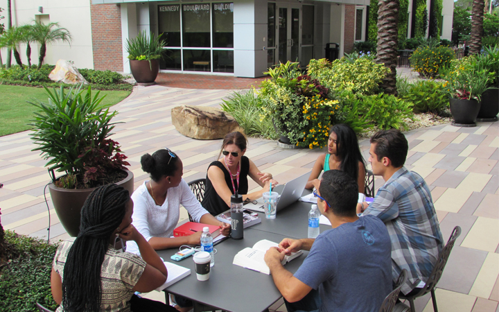 Students sitting with their professor having a discussion