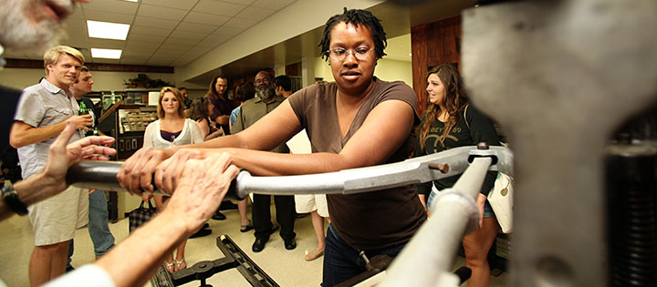 A student participates in the binding of a book.