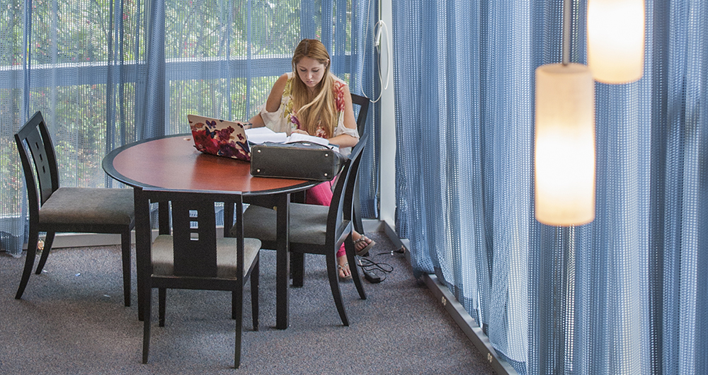 Lady studying at a table 