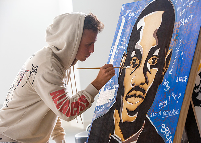 Student painting a portrait