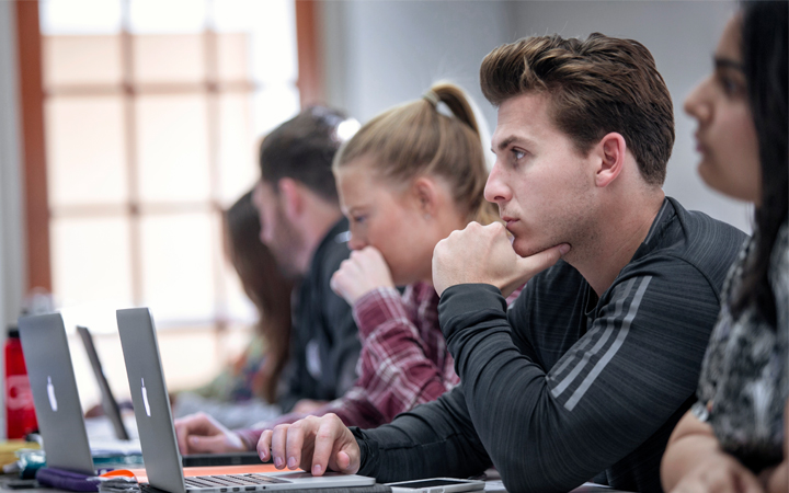 Students in class using laptops