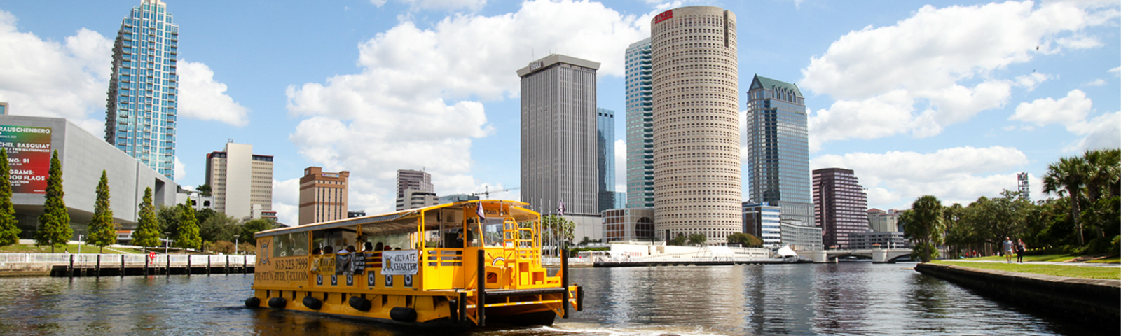 boat on the river with tampa skyline