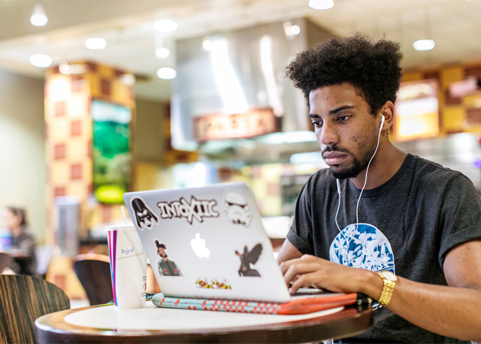 student doing work on his laptop