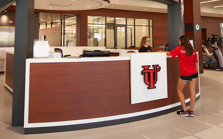 Student checking in at the desk in the fitness center