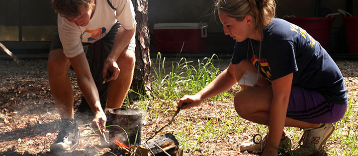 Students starting a campfire 