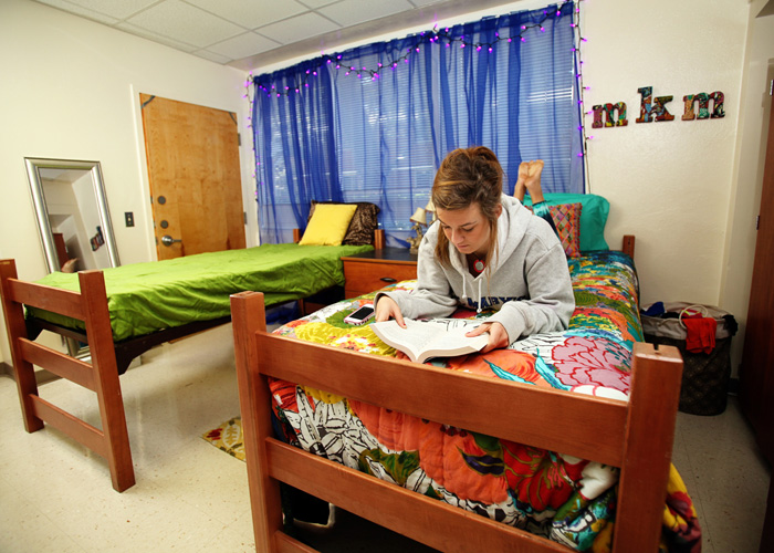 Student sitting on her bed