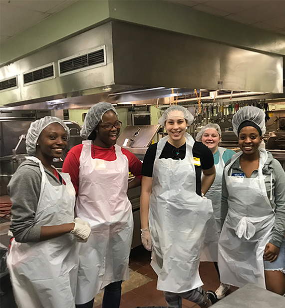 Students volunteering in a soup kitchen