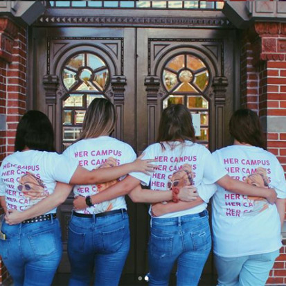 her campus members with her campus logo shirts on 