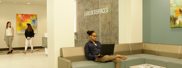 Student sitting in Career Services lobby