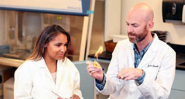 Faculty and student working in a biology lab
