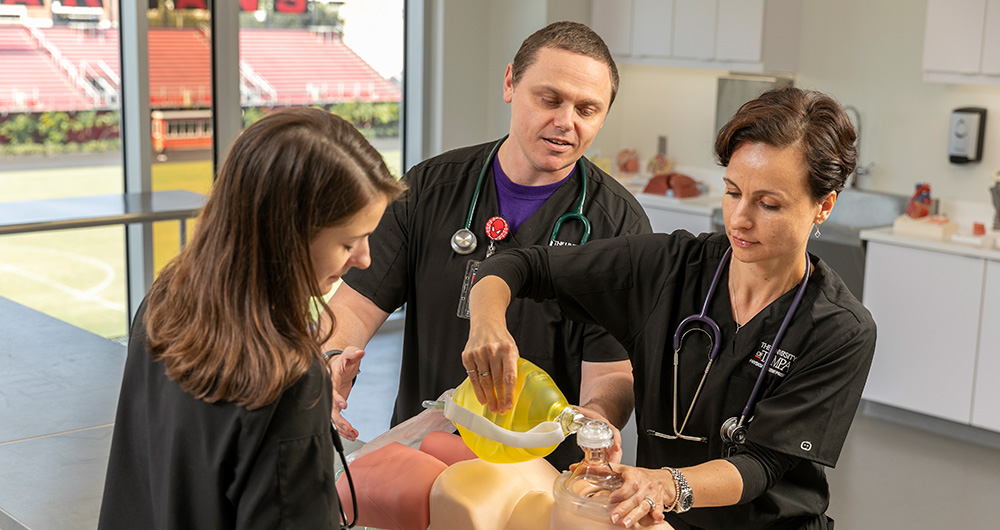 Two Physician Assistant Medicine students practice their studies. 