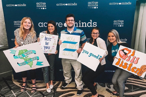 Students holding up inspirational posters 