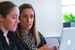 Two students working on computer 