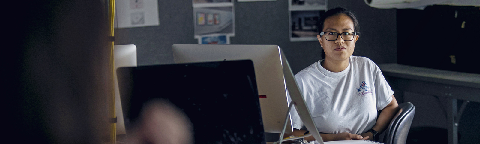Instructor teaching a student in a computer lab