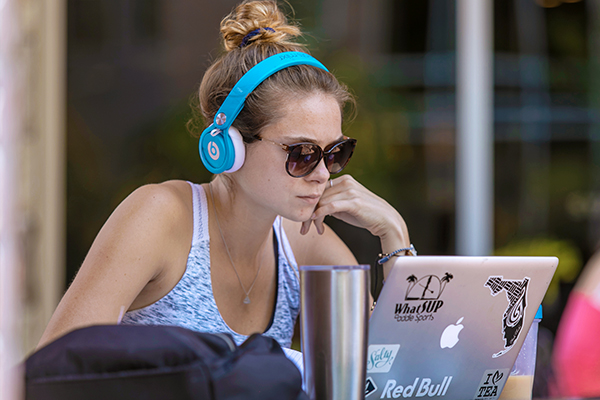 Student studying with headphones on
