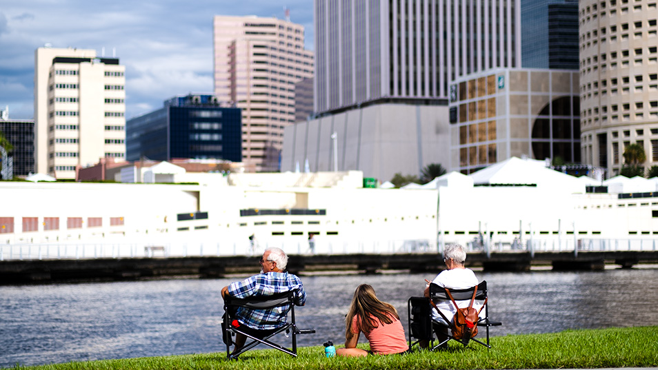 Student with grandparents sitting by the river