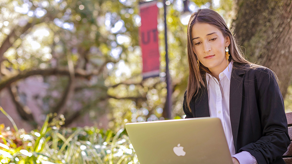 Girl working on laptop outside