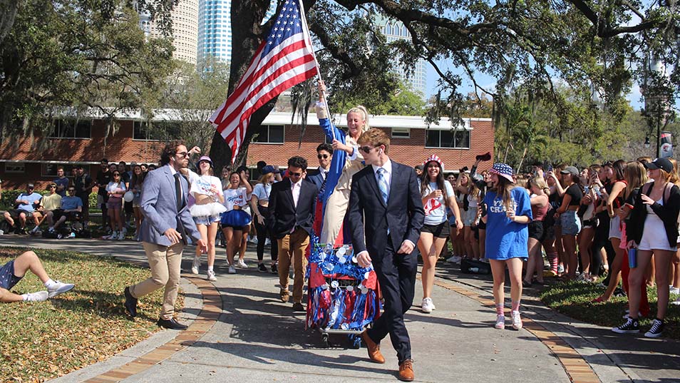 Greek Week parade through the Sykes College of Business lawn