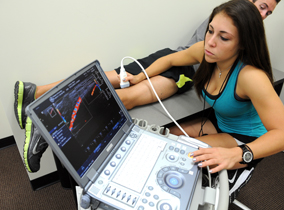 Student doing an ultrasound of a leg