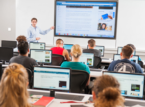 A classroom with computer work stations in the College of Business.