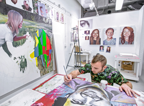 Student painting in a studio