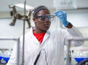 Student looking at a tube