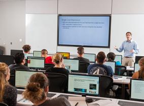 A classroom with computer work stations in the College of Business.