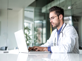 Medical professional using a laptop