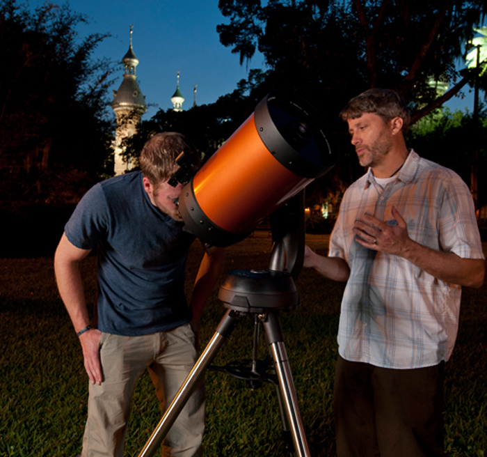 Student looking at stars through a telescope