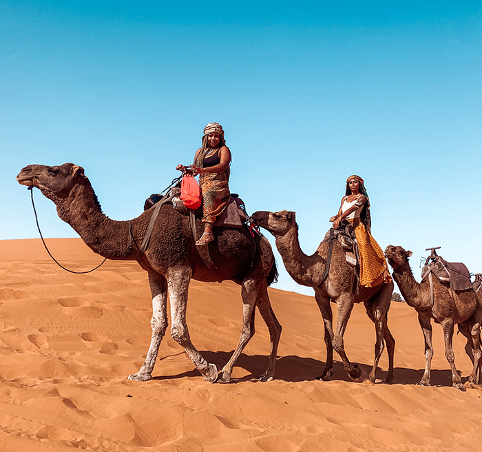 students riding a camel 