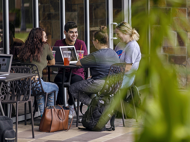 Students sitting outside of Starbucks