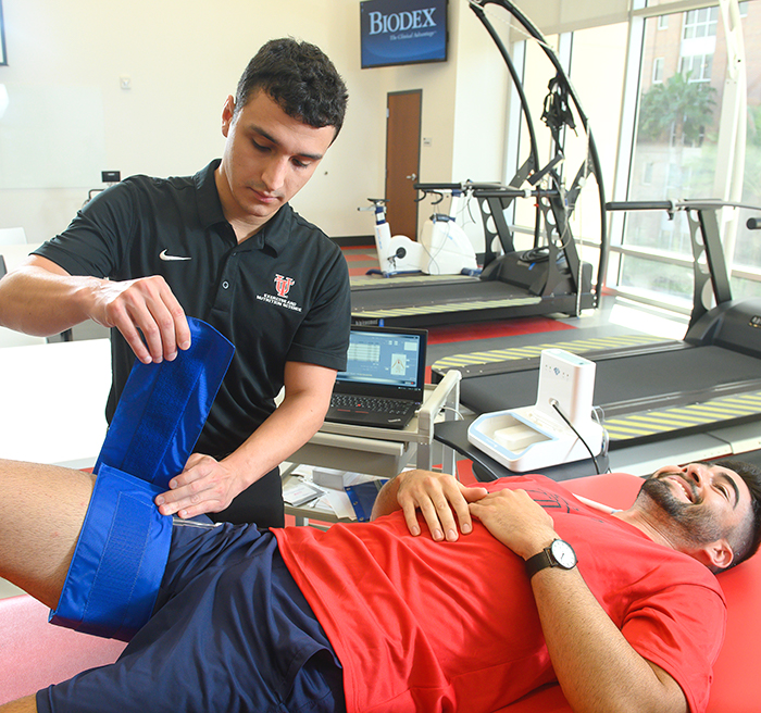 Student testing muscle performance on another student