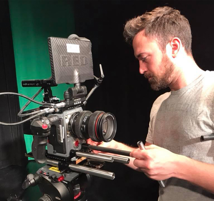 student working with video camera in studio 