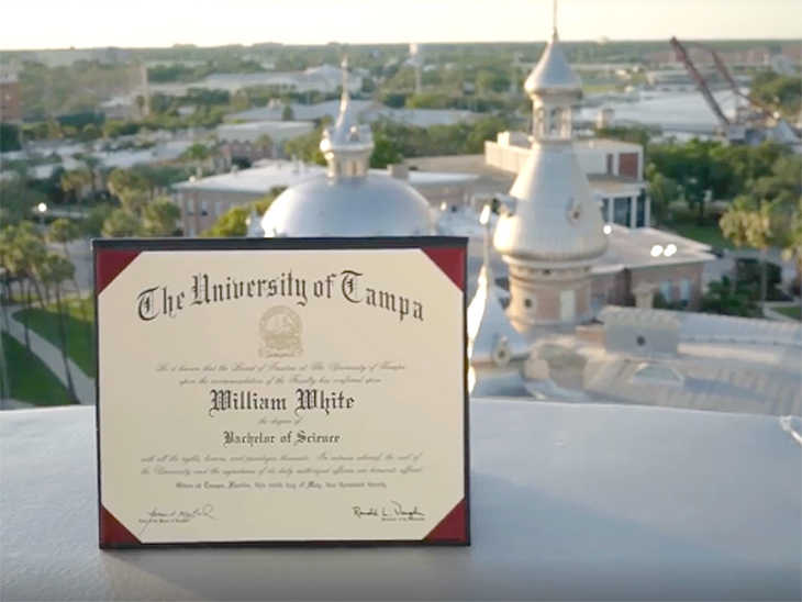 UT diploma sitting on a keyhole of a minaret with the UT campus in the background.