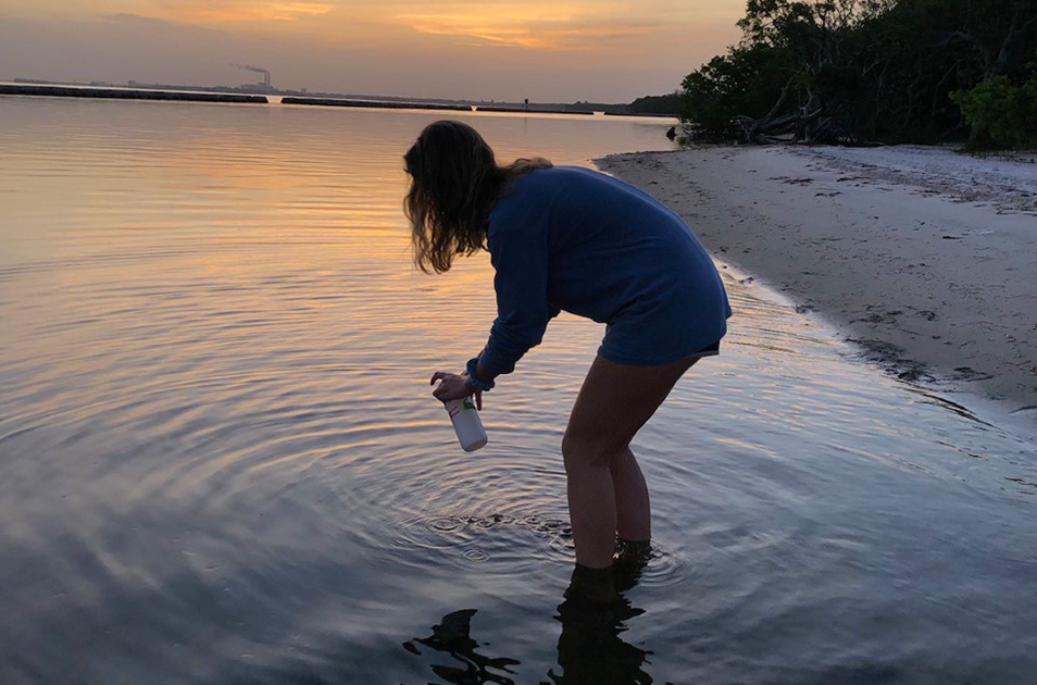 Haley Kudzmas taking a water sample at Gandy Beach.