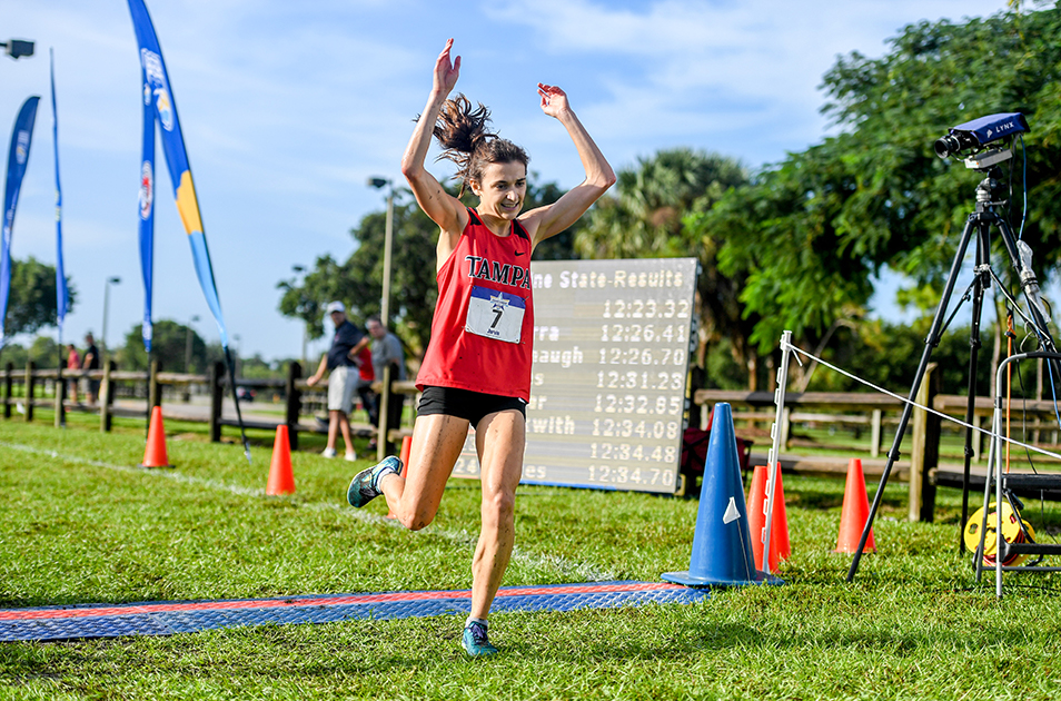 Zoe Jarvis running across a finish line