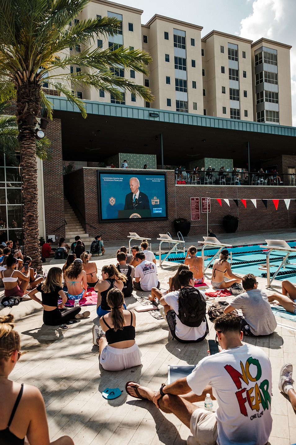 Students watching President Biden at the Riseman Acquatic Center.