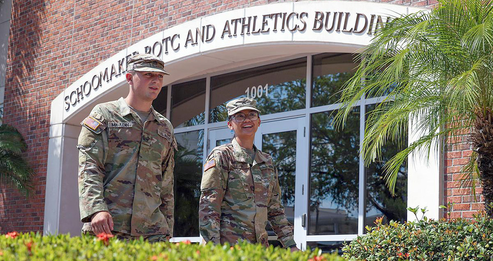 ROTC members in front of a helicopter